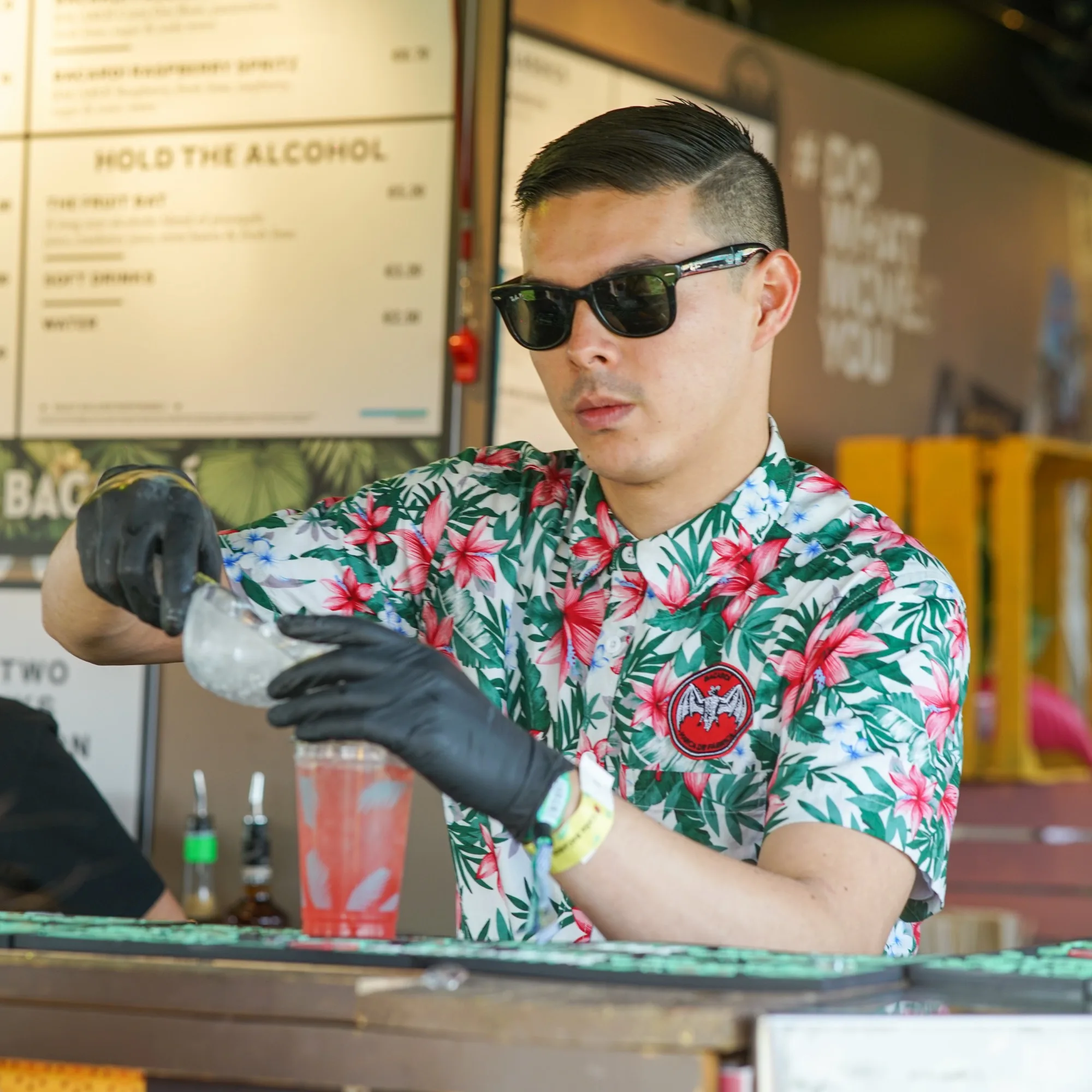 A bartender in a hibiscus shirt mixing the perfect serve