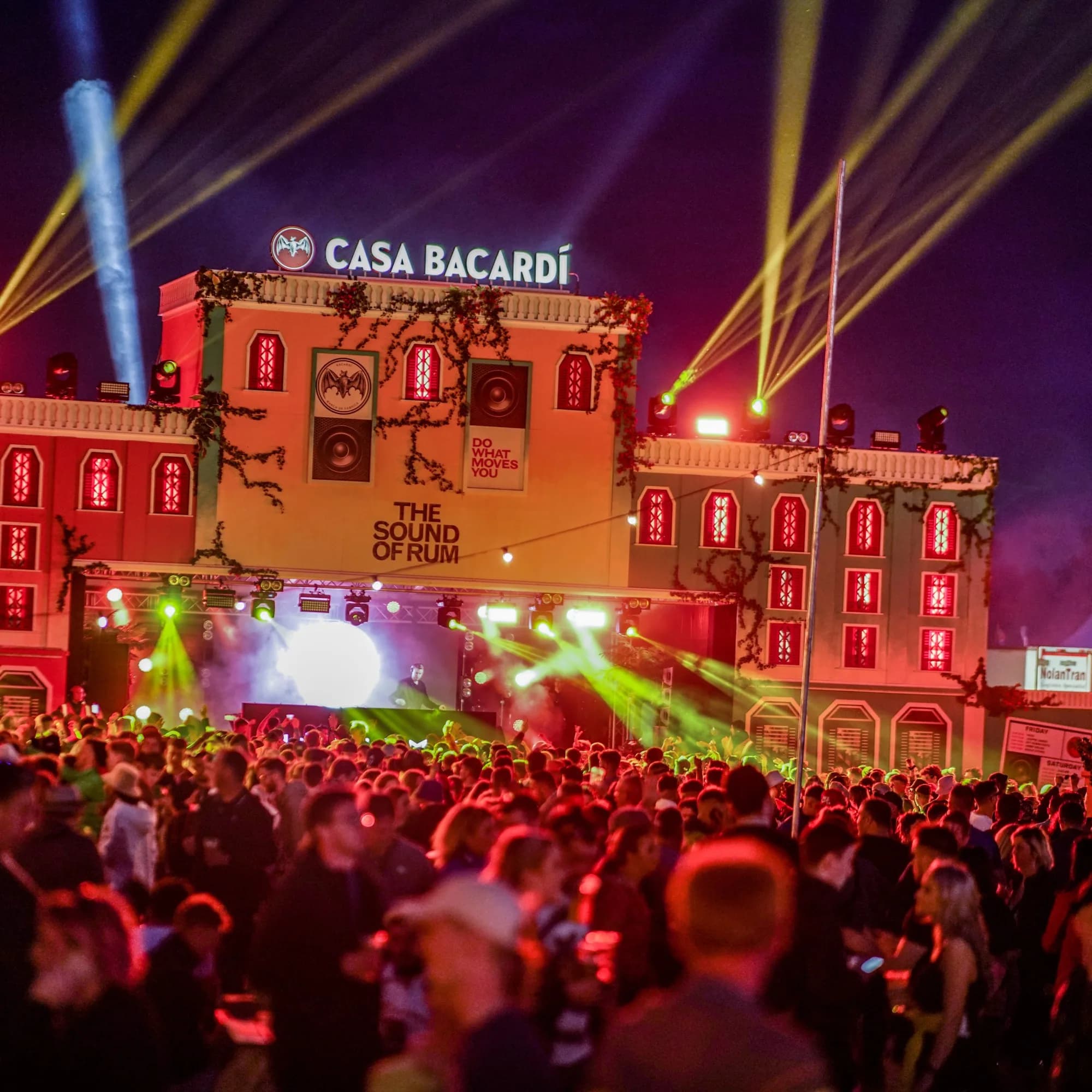 The Casa Bacardí facade lit red with lasers over a night crowd