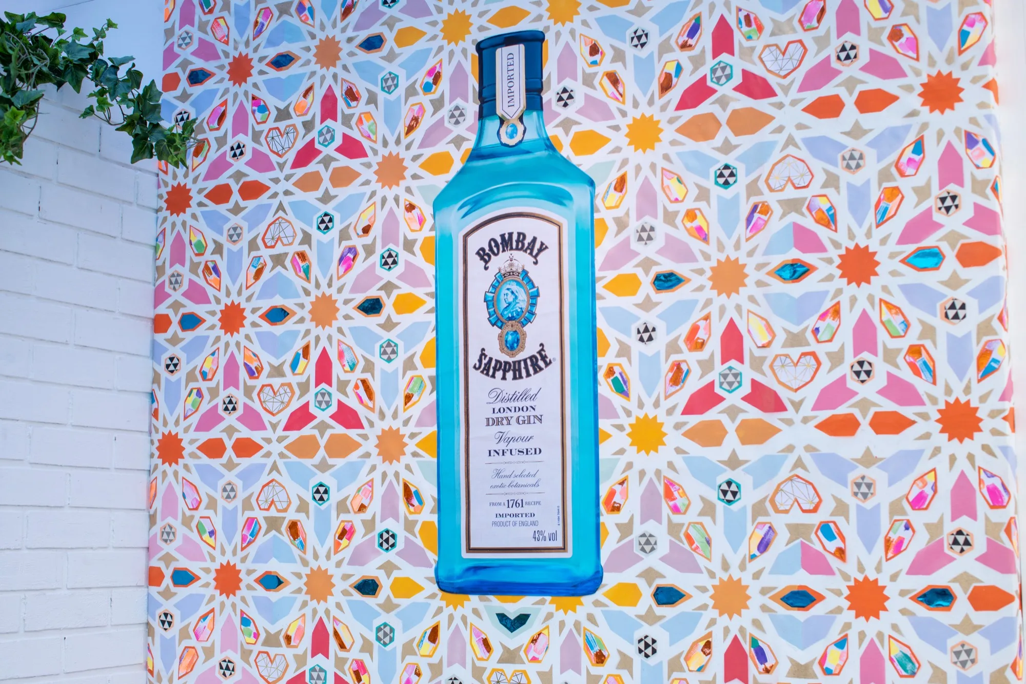 Bombay Sapphire bottle against a vivid geometric tile mural