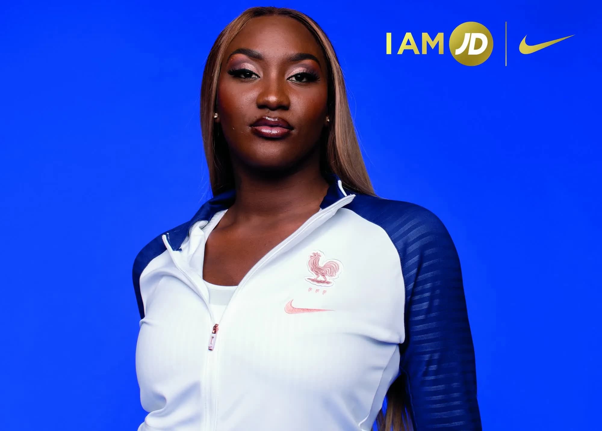 Aya Nakamura in a France kit against blue, with the IAM JD × Nike lockup