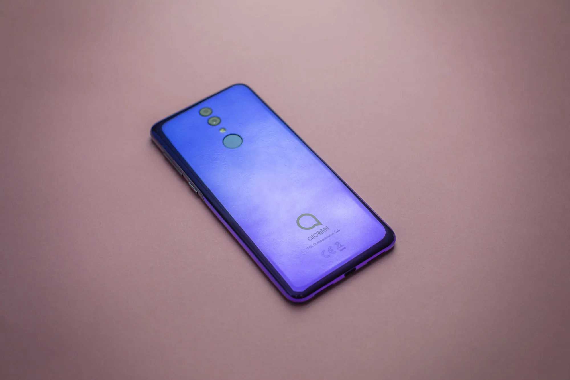 Blue-purple gradient Alcatel 3 on a dusty pink surface