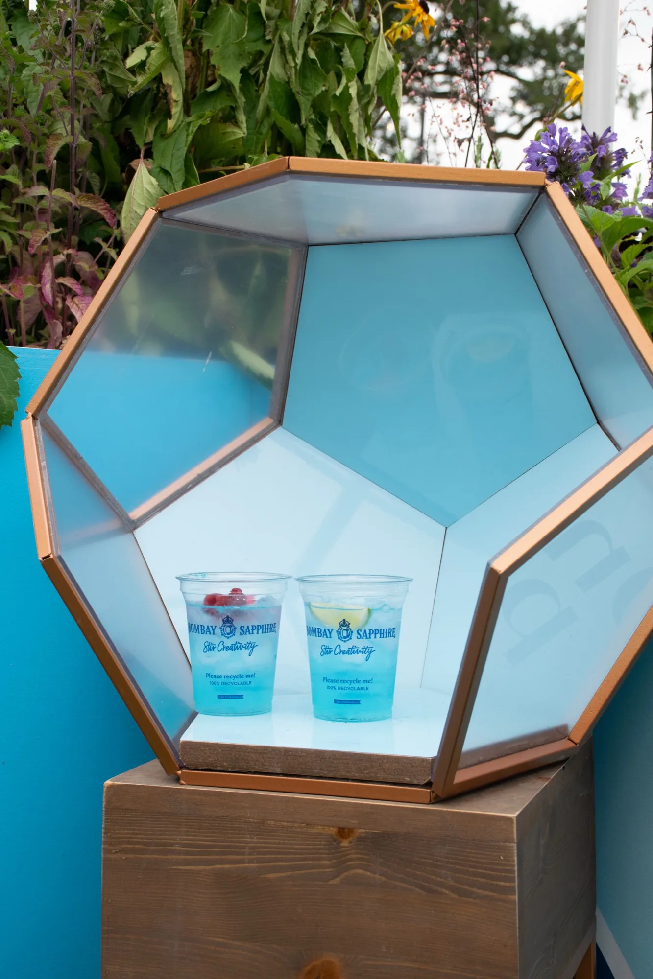 Geodesic display case holding two finished serves