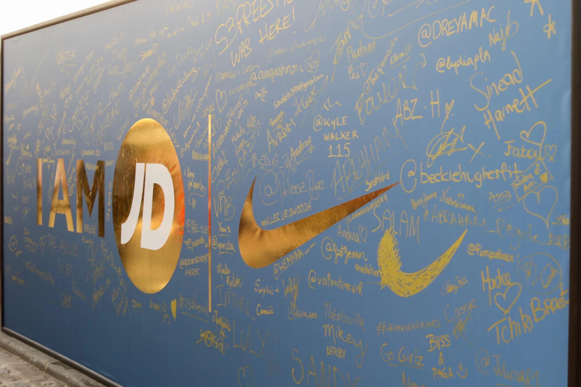 The gold IAM JD × Nike signature wall covered in guests' messages