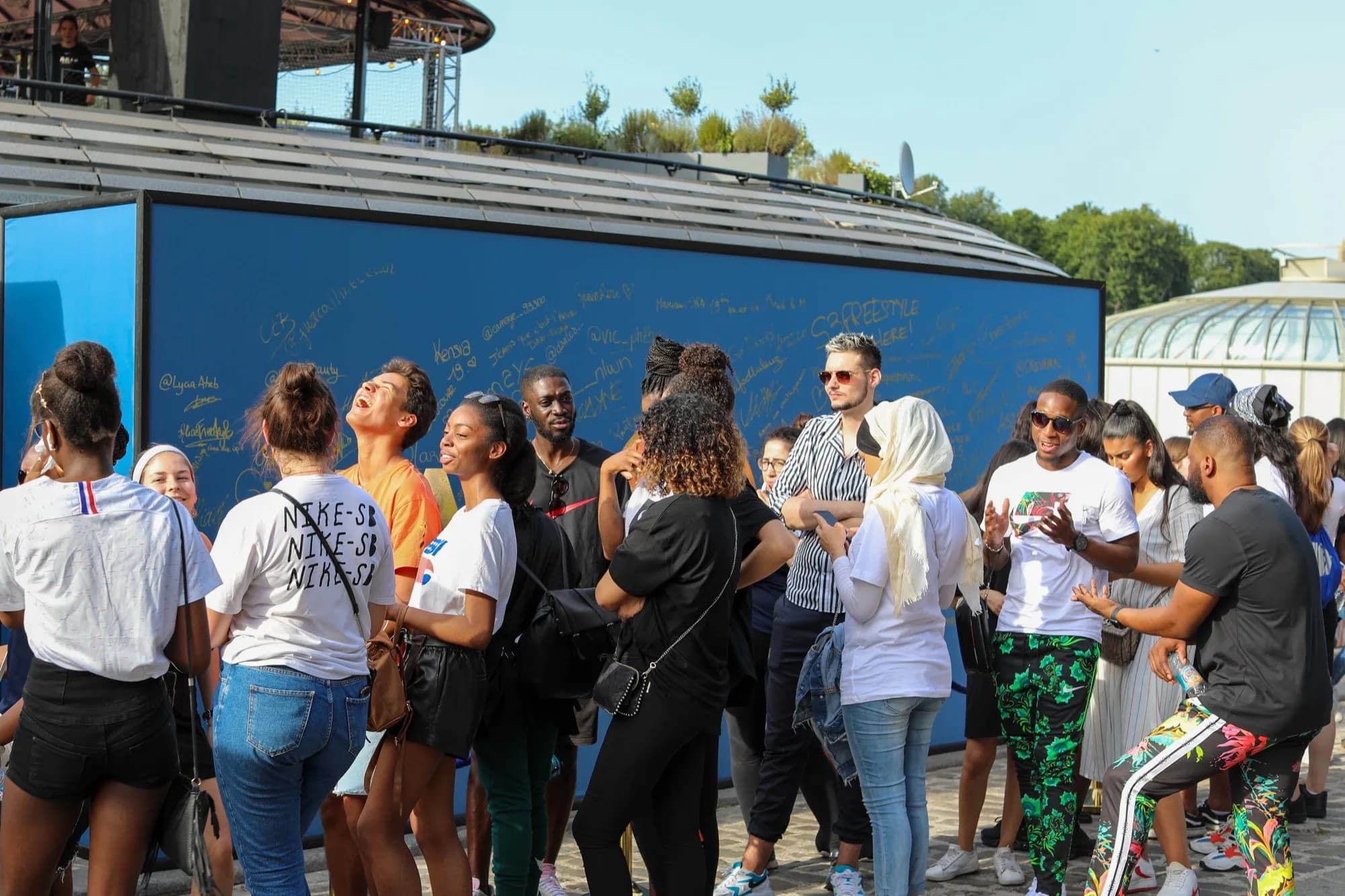 Attendees gathered at the signature wall in Paris